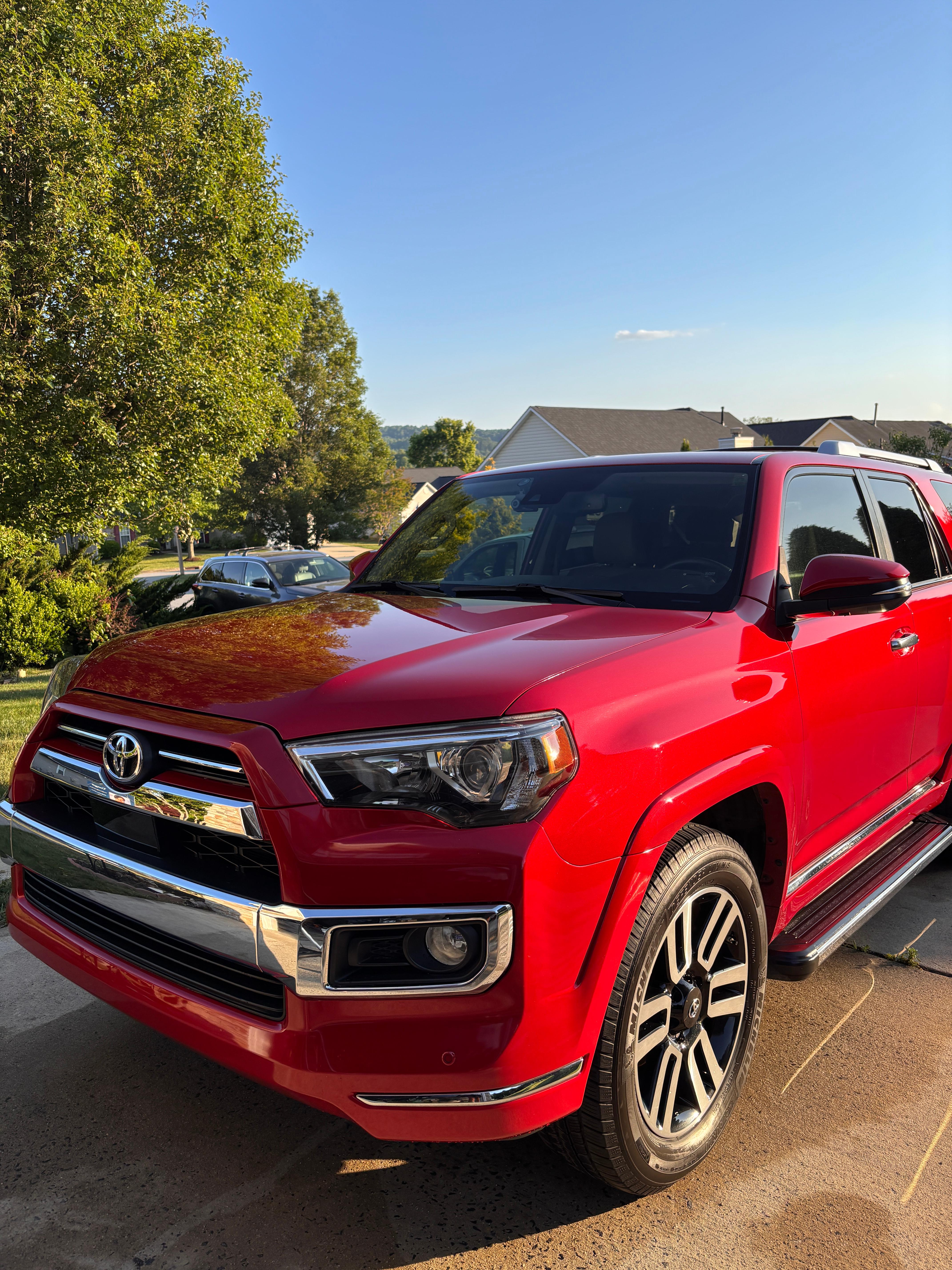 A freshly detailed, glossy red Toyota 4Runner in a driveway